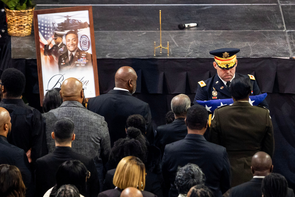 FILE - Katherine Shah, seated in the front row, is presented with a folded American Flag during a funeral for her late husband, Lt. Col. Brandon Shah, at Old Dominion University in Norfolk, Va., March 22, 2026. (Kendall Warner/The Virginian-Pilot via AP, File)