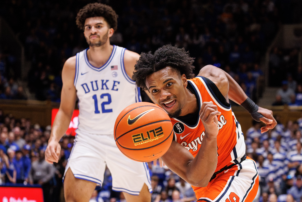 Syracuse's J.J. Starling, right, chases the ball ahead of Duke's Cameron Boozer (12) during the first half of an NCAA college basketball game in Durham, N.C., Monday, Feb. 16, 2026. (AP Photo/Ben McKeown)