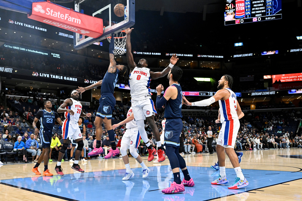 Memphis Grizzlies guard Ja Morant (12) shoots against Detroit Pistons center Jalen Duren (0) in the first half of an NBA Cup basketball game Monday, Nov. 3, 2025, in Memphis, Tenn. (AP Photo/Brandon Dill)