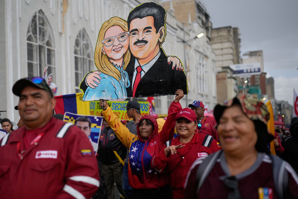 Government supporters carry a cutout of former President Nicolás Maduro and his wife Cilia Flores during a rally marking the anniversary of the 1958 coup that overthrew Venezuelan dictator Marcos Pérez Jiménez, in Caracas, Venezuela, Friday, Jan. 23, 2026. (AP Photo/Ariana Cubillos)