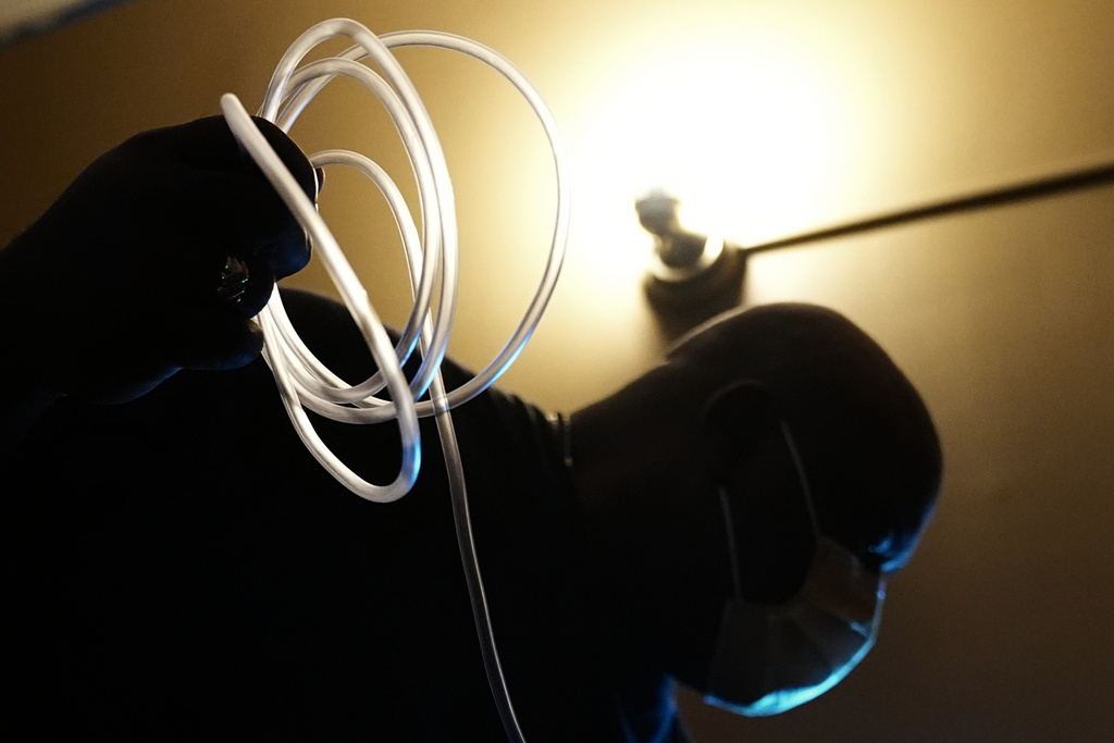Ahmad Collins, a city government worker and former Penn State linebacker, prepares for his nightly dialysis treatment at his home in Harrisburg, Pa., Thursday, Dec. 11, 2025. (AP Photo/Matt Rourke)