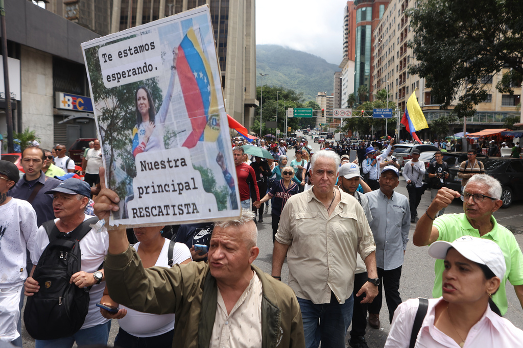 Trade union members march to demand that the government announce a timetable for presidential elections in Caracas, Venezuela, Wednesday, July 8, 2026. 2026. (AP Photo/Pedro Mattey)