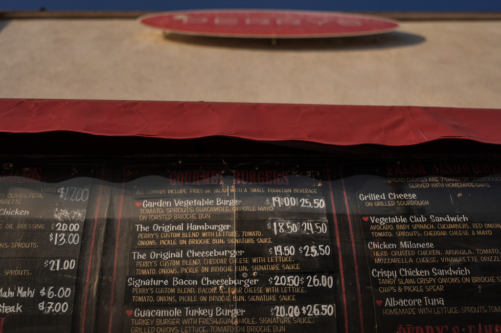 Menu prices are displayed at a cafe in Santa Monica, Calif., Wednesday, May 20, 2026. (AP Photo/Jae C. Hong)