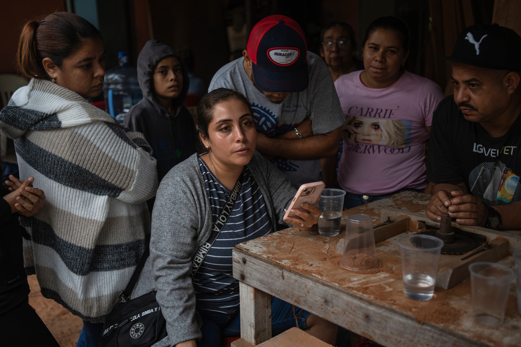 Relatives of Lt. Luis Enrique Castillo, a victim of a Mexican Navy plane crash off the Texas coast, learn about his death, at the family house in El Pantano, Veracruz state, Mexico, Tuesday, Dec. 23, 2025. (AP Photo/Felix Marquez)