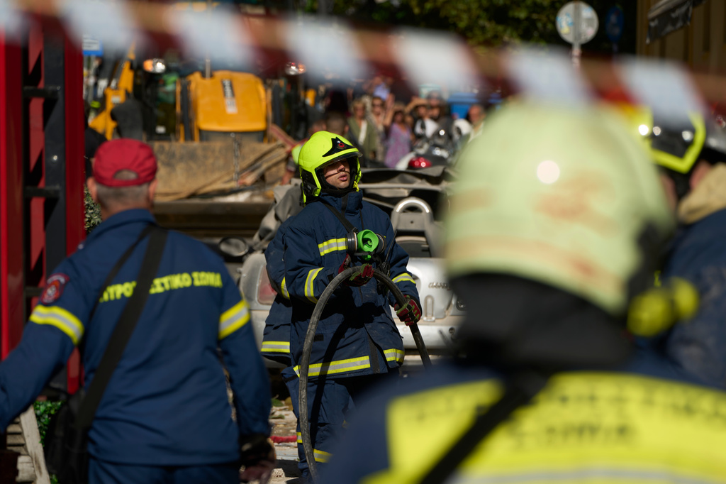 Firefighters work at the scene following a powerful blast that caused a building to collapse and injured at least two people in Athens' Plaka district, Friday, Sept. 25, 2026. (AP Photo/Petros Giannakouris)