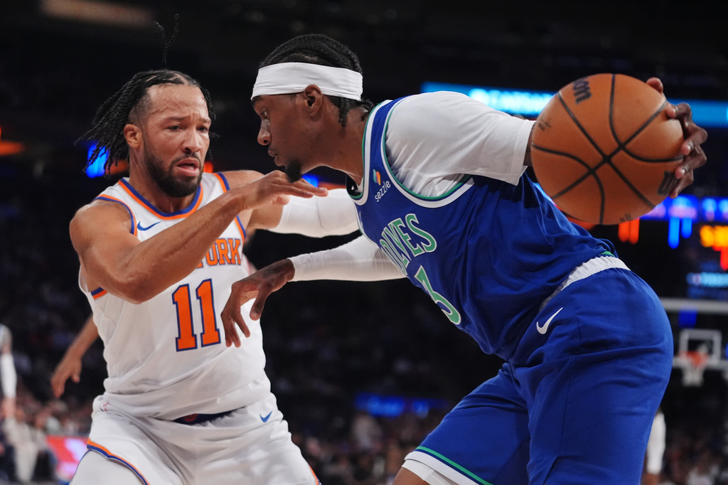 New York Knicks' Jalen Brunson (11) defends Minnesota Timberwolves' Jaden McDaniels (3) during the first half of a preseason NBA basketball game Monday, Oct. 12, 2026, in New York. (AP Photo/Frank Franklin II)