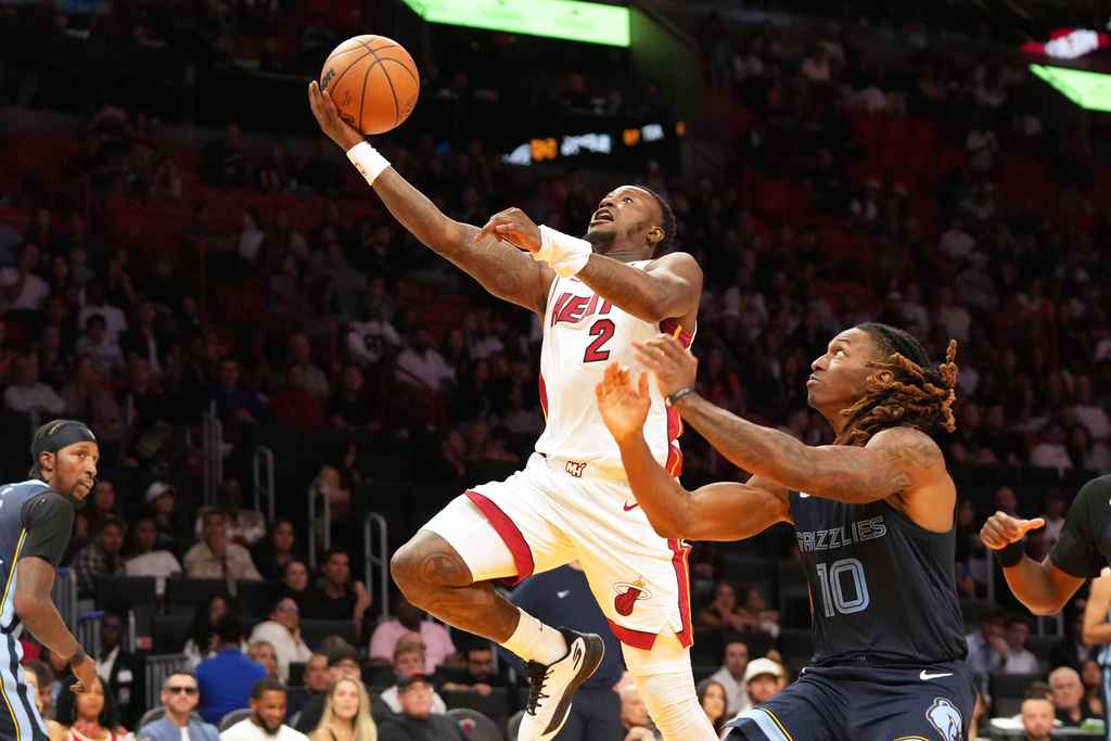 FILE - Miami Heat guard Terry Rozier (2) drives to the basket as Memphis Grizzlies guard Javon Small (10) defends during the second half of an NBA preseason basketball game Friday, Oct. 17, 2025, in Miami. (AP Photo/Marta Lavandier, File)