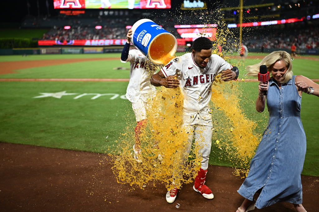 Los Angeles Angels' Christian Moore, center, is showered with an ice bucket after hitting a walk-off single during the 11th inning of a baseball game against the Minnesota Twins, Saturday, Sept. 19, 2026, in Anaheim, Calif. (AP Photo/William Liang)