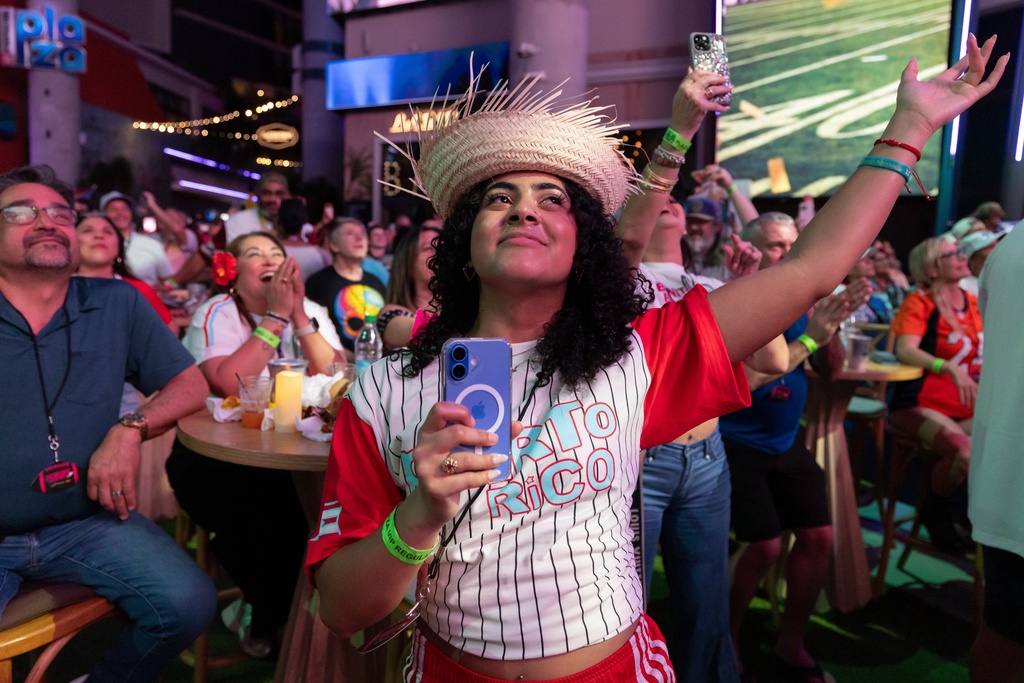 Fans in San Juan, Puerto Rico, watch Bad Bunny's performance on television during the halftime show of the NFL Super Bowl 60 football game Sunday, Feb. 8, 2026. (AP Photo/Alejandro Granadillo)