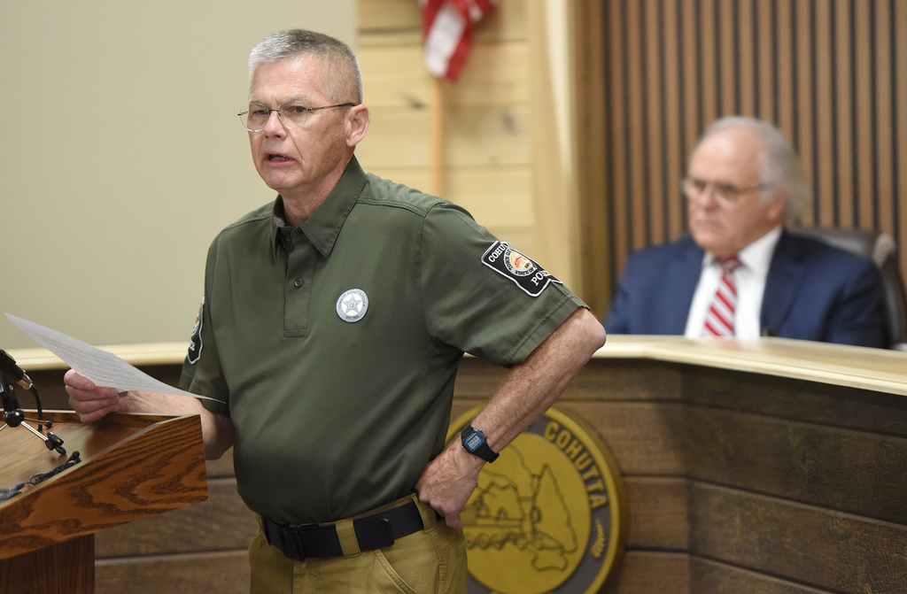 Mayor Ron Shinnick, back, looks on as police chief Greg Fowler reads a statement at Cohutta Town Hall in Cohutta, Ga. on Thursday, April 30, 2026. (Matt Hamilton/Chattanooga Times Free Press via AP)