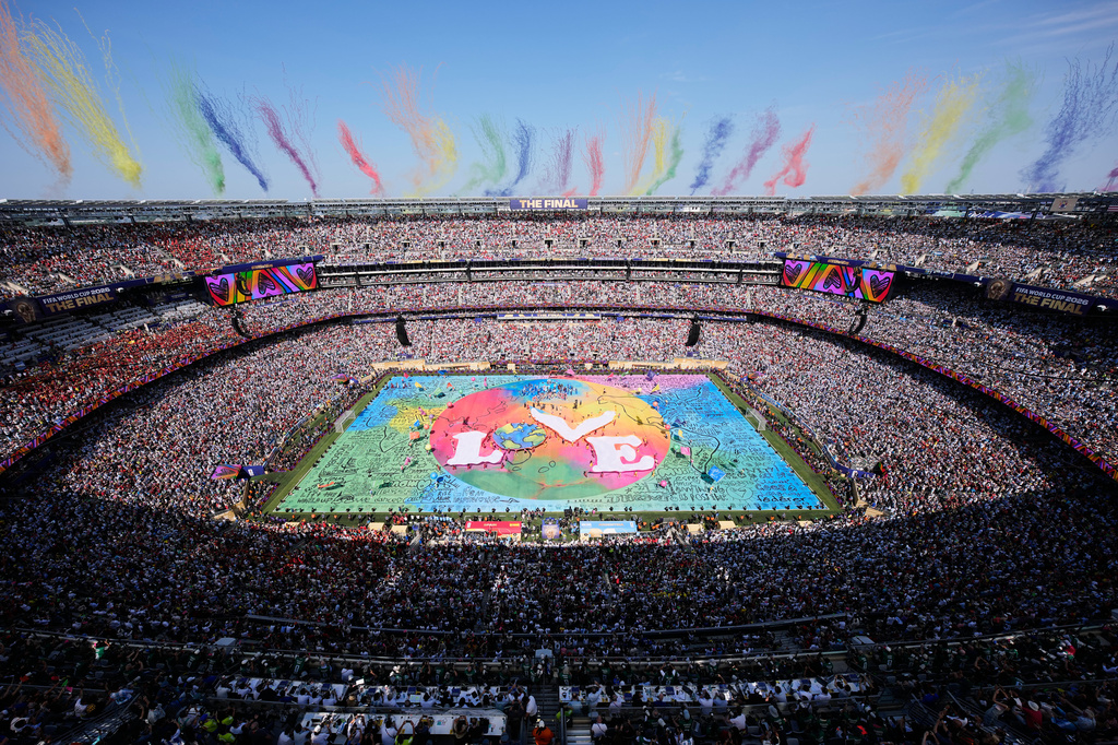 Dancers perform as colorful smoke rises above the stadium during the halftime show at the World Cup final soccer match between Spain and Argentina in East Rutherford, N.J., near New York, Sunday, July 19, 2026. (AP Photo/Matt Slocum)