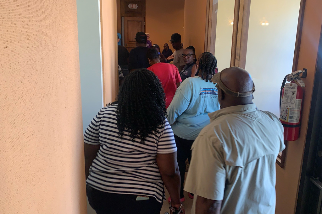 Families of the shooting victims head into a meeting with authorities at Leland City Hall on Saturday, Oct. 11, 2025 in Leland, Miss. (AP Photo/Katie Adkins)
