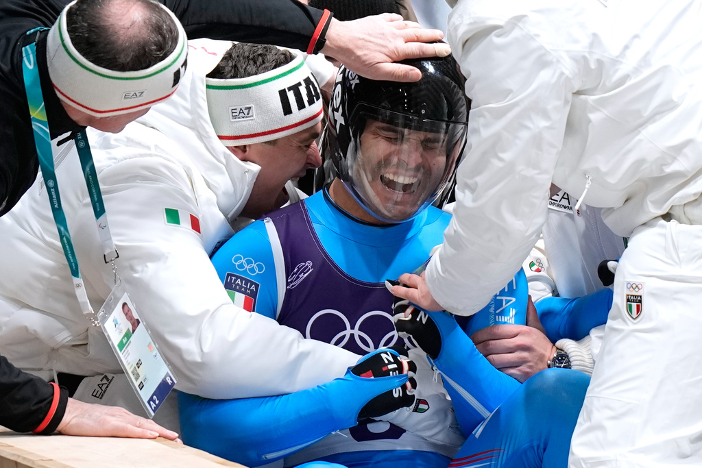 Italy's Emanuel Rieder and Simon Kainzwaldner celebrate as they arrive at the finish during a men's doubles luge run at the 2026 Winter Olympics, in Cortina d'Ampezzo, Italy, Wednesday, Feb. 11, 2026. (AP Photo/Aijaz Rahi)