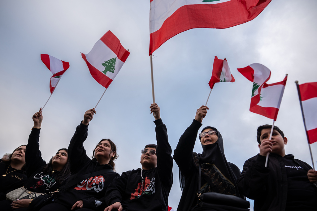 People wave Lebanese flags during a vigil for people killed in Lebanon during the Iran war, Friday, April 10, 2026, in Dearborn, Mich. (AP Photo/Julia Demaree Nikhinson)