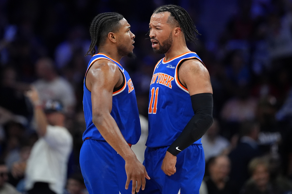 New York Knicks' Miles McBride, left, and Jalen Brunson celebrate during the first half of Game 4 against the Philadelphia 76ers in a second-round NBA basketball playoffs series Sunday, May 10, 2026, in Philadelphia. (AP Photo/Matt Slocum)