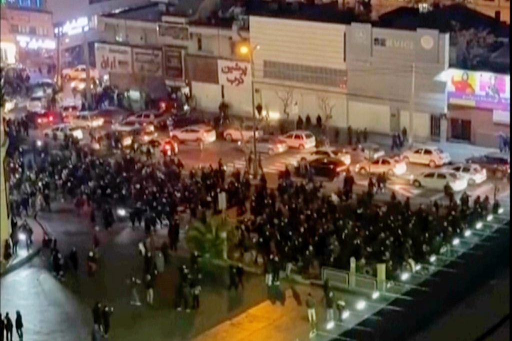 FILE - In this image from video made by an individual not employed by The Associated Press and obtained by the AP outside Iran, people block an intersection during a protest in Tehran, Iran, on Jan. 8, 2026. (UGC via AP, File)