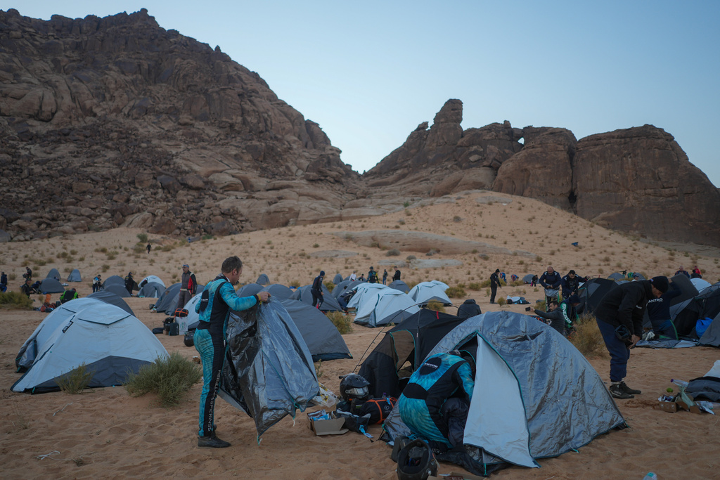 Drivers and co-drivers pack up their tents before the start of the fifth stage of the Dakar Rally between Alula and Hail, Saudi Arabia, Thursday, Jan. 8, 2026. (AP Photo/Thibault Camus)