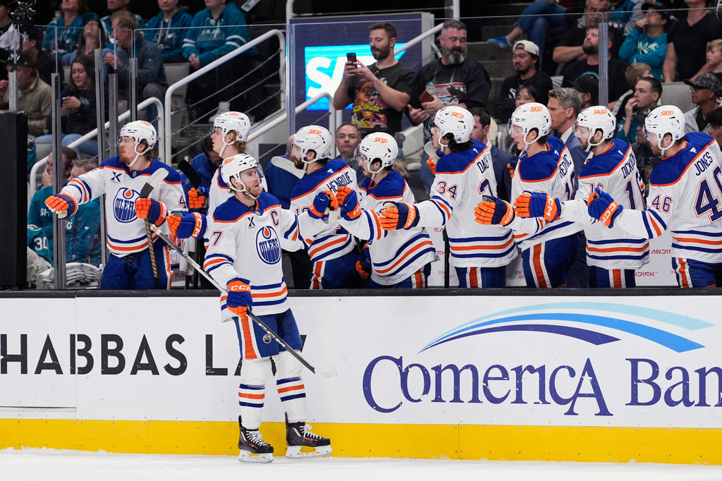 Edmonton Oilers center Connor McDavid (97) celebrates with teammates after scoring a goal during the first period of an NHL hockey game against the San Jose Sharks, Wednesday, April 8, 2026, in San Jose, Calif. (AP Photo/Godofredo A. Vásquez)