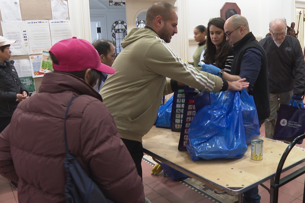 A volunteer helps gather bags of food at the Holy Apostles Soup Kitchen and Pantry in the Chelsea neighborhood of Manhattan in New York, on Wednesday, Oct. 29, 2025. (AP Photo/Joseph B. Frederick)