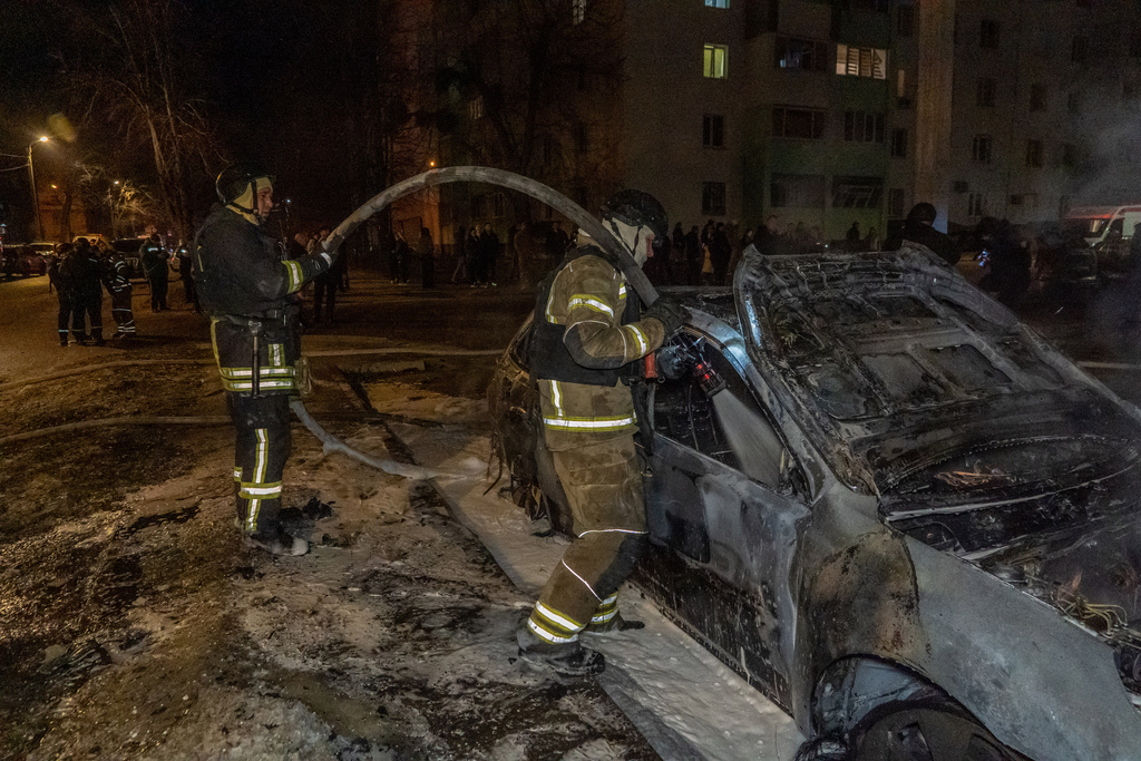 Rescuers put out the fire at a residential neighbourhood following Russia's drone attack in Kharkiv, Ukraine, late Monday, March 9, 2026. (AP Photo/Andrii Marienko)