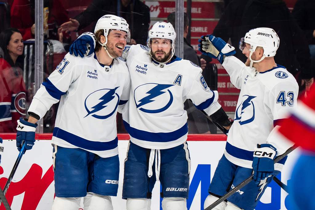 Tampa Bay Lightning' Charle-Edouard D'Astous (51) celebrates his goal with teammates Nikita Kucherov (86) and Darren Raddysh (43) during second period NHL hockey action against the Montreal Canadiens in Montreal on Tuesday, Dec. 9, 2025. (Christopher Katsarov/The Canadian Press via AP)