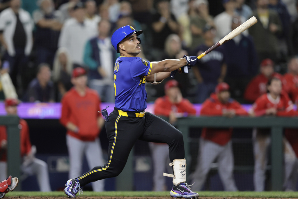 Seattle Mariners' Harry Ford hits a walkoff sacrifice fly against the Los Angeles Angels during the 12th inning of a baseball game Thursday, Sept. 11, 2025, in Seattle. (AP Photo/John Froschauer)