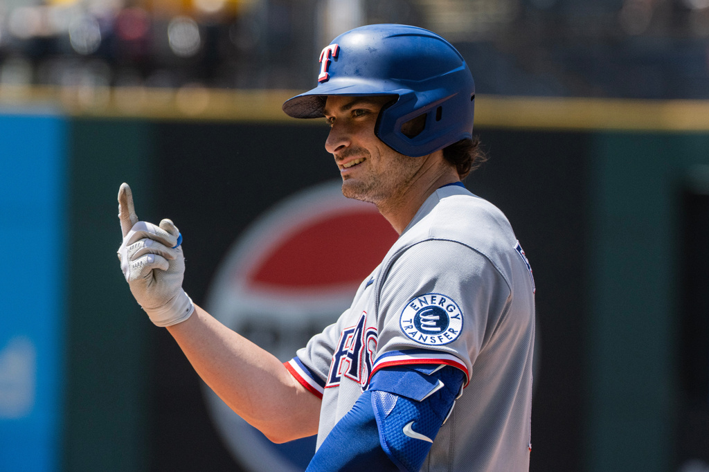 Texas Rangers' Justin Fosque reacts after hitting an infield single off Cleveland Guardians relief pitcher Colin Holderman during the sixth inning of a baseball game, Wednesday, July 1, 2026, in Cleveland. (AP Photo/Phil Long)