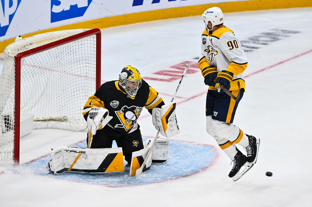 Penguins goalie Sergei Murashov and Predators Ryan O'Reilly in action during the NHL Global Series hockey game between the Pittsburgh Penguins and the Nashville Predators in Stockholm, Sweden, Sunday, Nov. 16, 2025. (Claudio Bresciani/TT News Agency via AP)