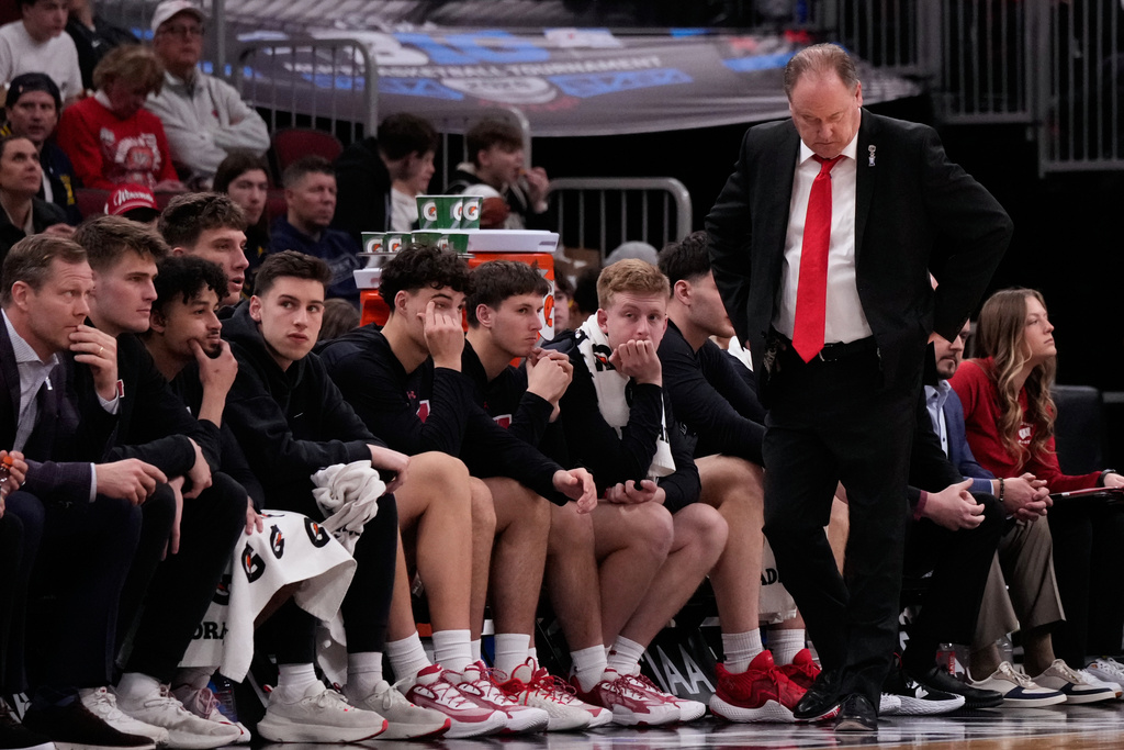 Wisconsin head coach Greg Gard, right, looks down as he watches his team during the second half of an NCAA college basketball game against Michigan in the semifinals of the Big 10 Conference tournament, Saturday, March 14, 2026, in Chicago. (AP Photo/Nam Y. Huh)