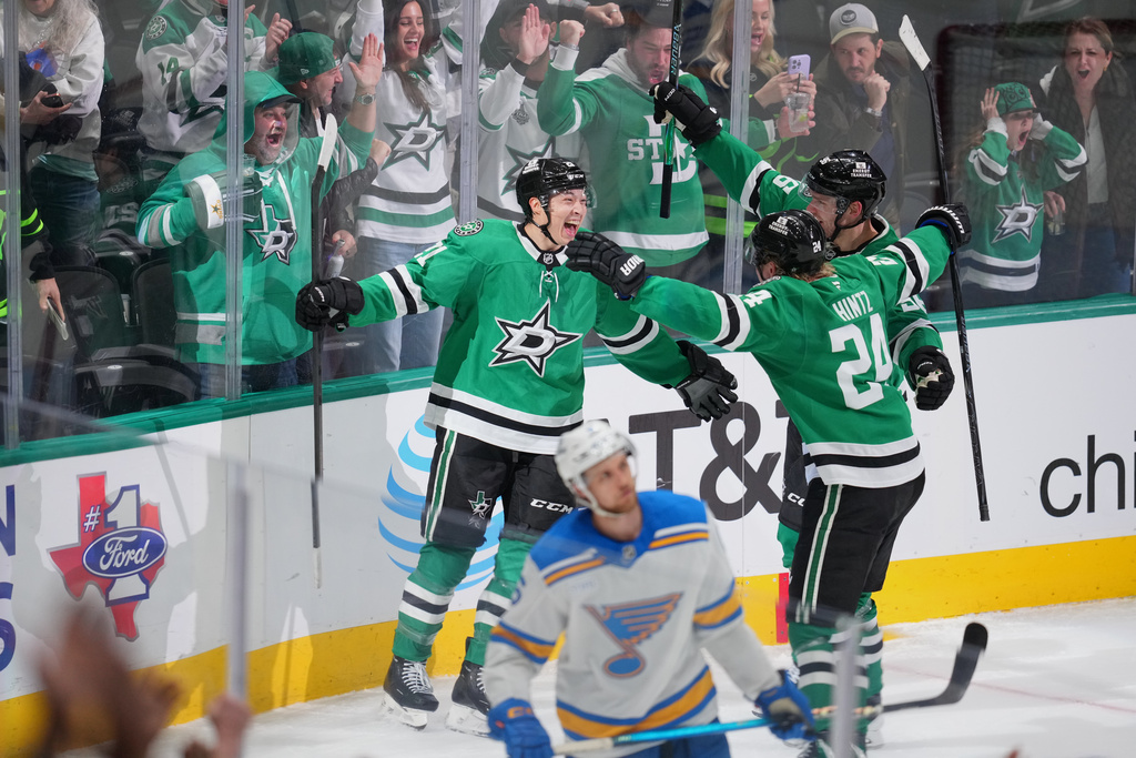 Dallas Stars left wing Jason Robertson, left, celebrates his third period goal with center Roope Hintz (24) and right wing Mikko Rantanen (96) during an NHL hockey game against the St. Louis Blues Friday, Jan. 23, 2026, in Dallas. (AP Photo/Julio Cortez)