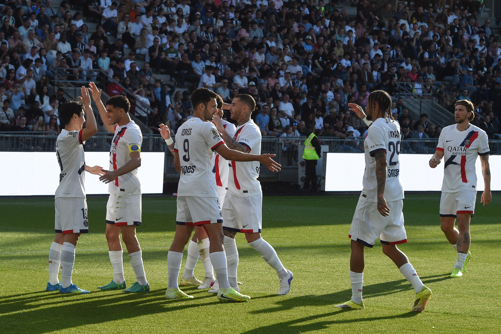 PSG's Lee Kang-in, left, celebrates with his teammates after scoring during the French League One soccer match between Angers and Paris Saint-Germain in Angers, western France, Saturday, April 25, 2026. (AP Photo/Mathieu Pattier)