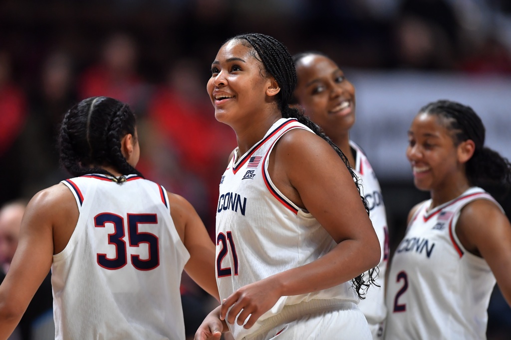 UConn forward Sarah Strong (21) celebrates with guards Azzi Fudd (35) and KK Arnold (2) as they lead Utah in the second half of an NCAA college basketball game, Sunday, Nov. 23, 2025, in Uncasville, Conn. (AP Photo/Steven Senne)