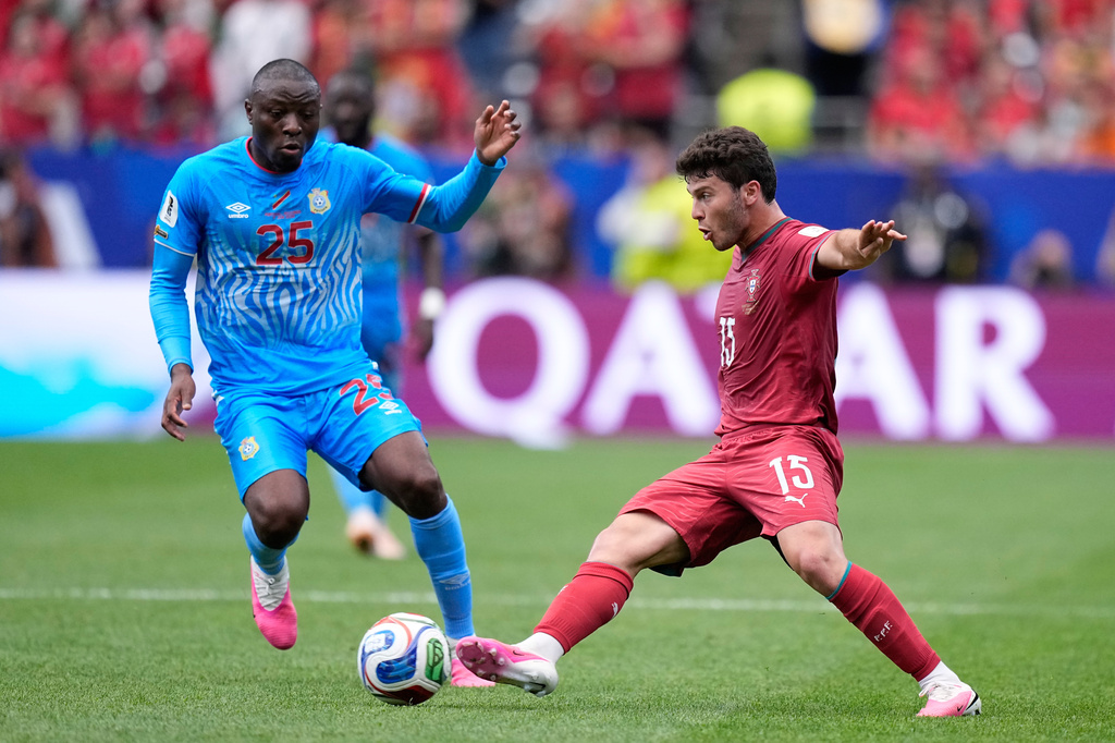 Portugal's Joao Neves vies for the ball with Congo's Edo Kayembe, left, during the World Cup Group K soccer match between Portugal and Congo in Houston, Wednesday, June 17, 2026. (AP Photo/Ashley Landis)