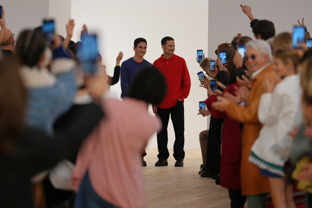 Creation directors Jack McCullough, right, and Lazaro Hernandez get applause after Loewe Spring/Summer 2026 collection presented in Paris, Friday, Oct. 3, 2025. (AP Photo/Aurelien Morissard)
