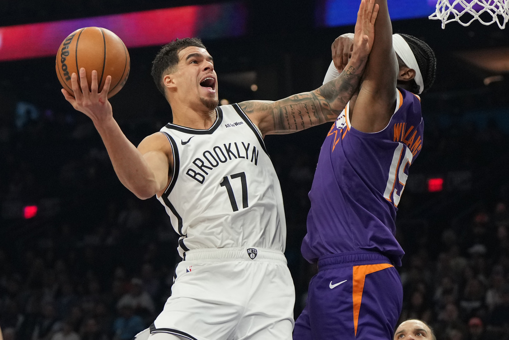 Brooklyn Nets forward Michael Porter Jr. shoots on Phoenix Suns center Mark Williams (15) during the first half of an NBA basketball game, Tuesday, Jan. 27, 2026, in Phoenix. (AP Photo/Rick Scuteri)