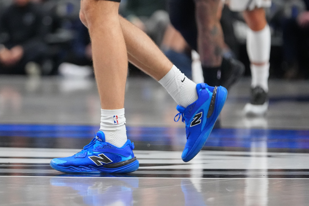 Dallas Mavericks forward Cooper Flagg walks on the court after briefly leaving to the locker room during the first half of an NBA basketball game against the Denver Nuggets Wednesday, Jan. 14, 2026, in Dallas. (AP Photo/Julio Cortez)
