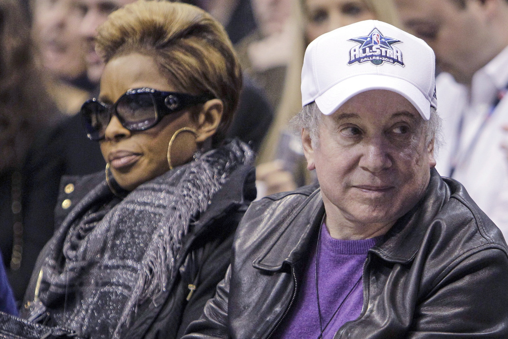 FILE - Songwriter Paul Simon, right, and singer Mary J. Blige attend the skills competition at the NBA basketball All-Star Saturday Night on Feb. 13, 2010, in Dallas. (AP Photo/Eric Gay, file)