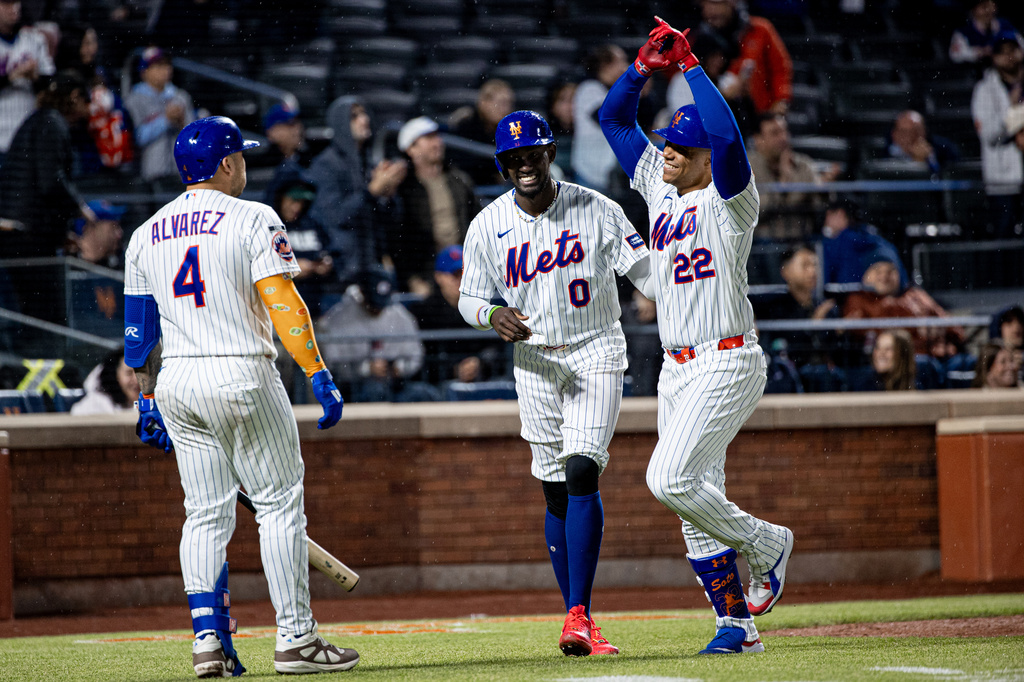 New York Mets' Ronny Mauricio (0) Juan Soto (22) celebrate scoring on Soto's two-run home run during the fourth inning of a baseball game against the Washington Nationals, Tuesday, April 28, 2026, in New York. (AP Photo/Angelina Katsanis)