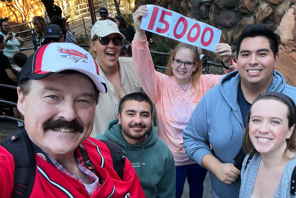 In this photo provided by Jon Alan Hale, Hale, left, poses with friends after taking his 15,000th Radiator Springs Racers ride at Disney California Adventure in Anaheim, Calif., Monday, Dec. 8, 2025. (Jon Alan Hale via AP)