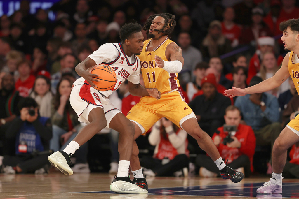 St. John's Ian Jackson, left, fouls Iona's CJ Anthony during the first half of an NCAA college basketball game Saturday, Dec. 13, 2025, in New York. (AP Photo/Pamela Smith)