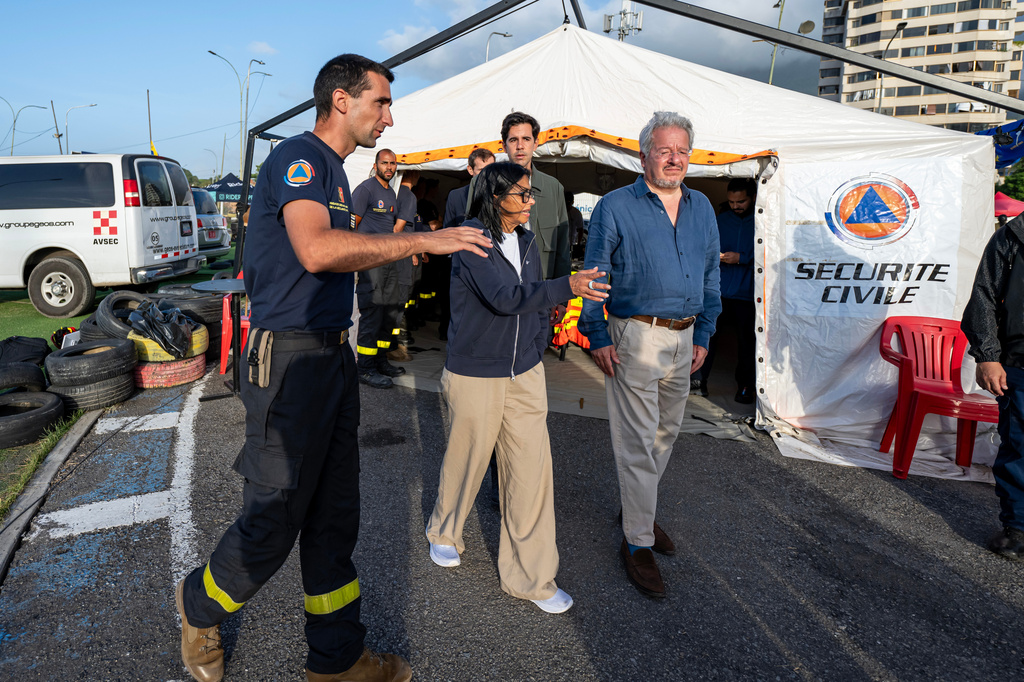 Lieutenant-Colonel Vianney Labbe, left, head of the detachment of the French 7th Civil Security Training and Intervention Regiment (RIISC 7), Venezuela's interim President Delcy Rodriguez, center, Oliver Blanco, Venezuela's Vice Minister for Europe and North America, and French ambassador to Venezuela Emmanuel Pineda, right, visit a temporary camp of the French Civil Security in La Guaira, Wednesday, July 1, 2026, following the June 24 earthquakes. (Miguel Medina/Pool Photo via AP)