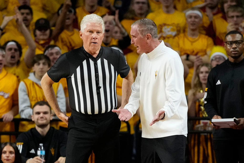 Arizona State head coach Bobby Hurley, right, questions a call during the first half of an NCAA college basketball game against Iowa State, Saturday, March 7, 2026, in Ames, Iowa. (AP Photo/Charlie Neibergall)