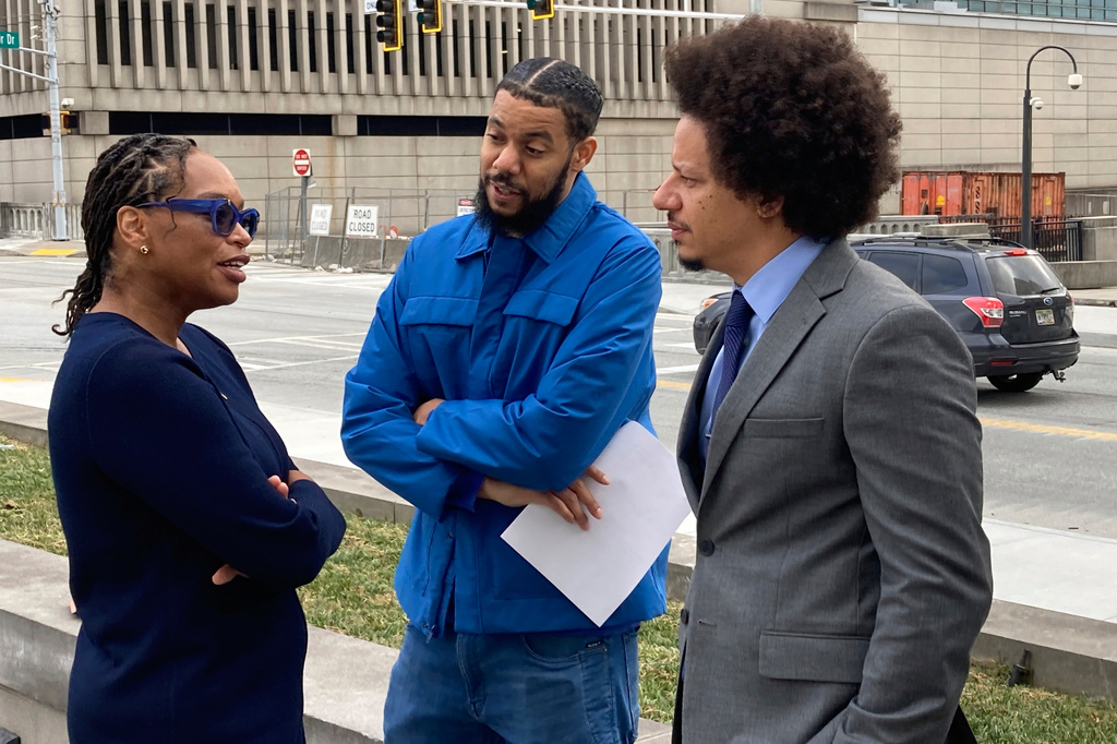 FILE - Comedians Clayton English, center, and Eric André, right, speak with their attorney, Allegra Lawrence-Hardy, outside the federal courthouse in Atlanta on Oct. 11, 2022. (AP Photo/Kate Brumback, File)