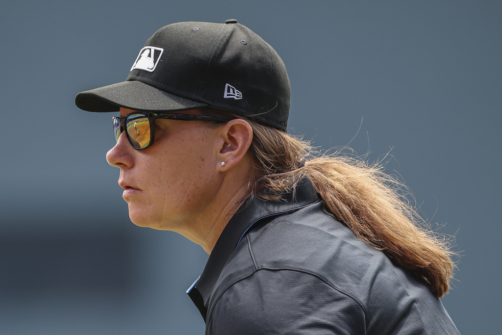 Umpire Jen Pawol, looks on during the first inning of a baseball game of a doubleheader between the Atlanta Braves and Miami Marlins, Saturday, Aug. 9, 2025, in Atlanta. (AP Photo/Colin Hubbard)