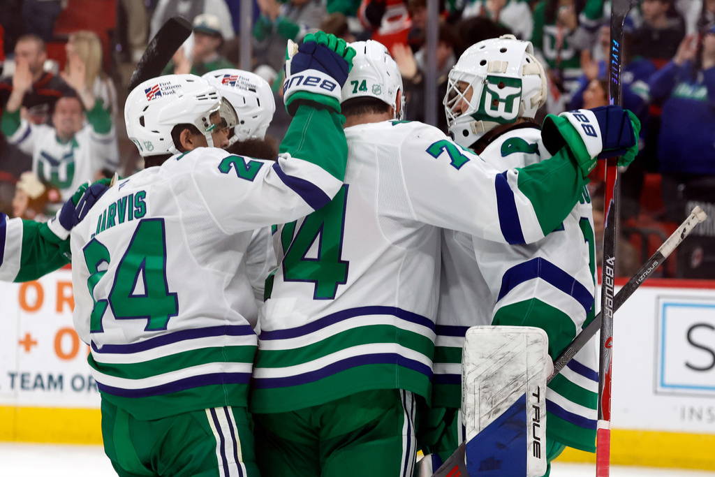 Carolina Hurricanes goaltender Brandon Bussi, right, is congratulated after his win over the Utah Mammoth in an NHL hockey game in Raleigh, N.C., Thursday, Jan. 29, 2026. (AP Photo/Karl DeBlaker)