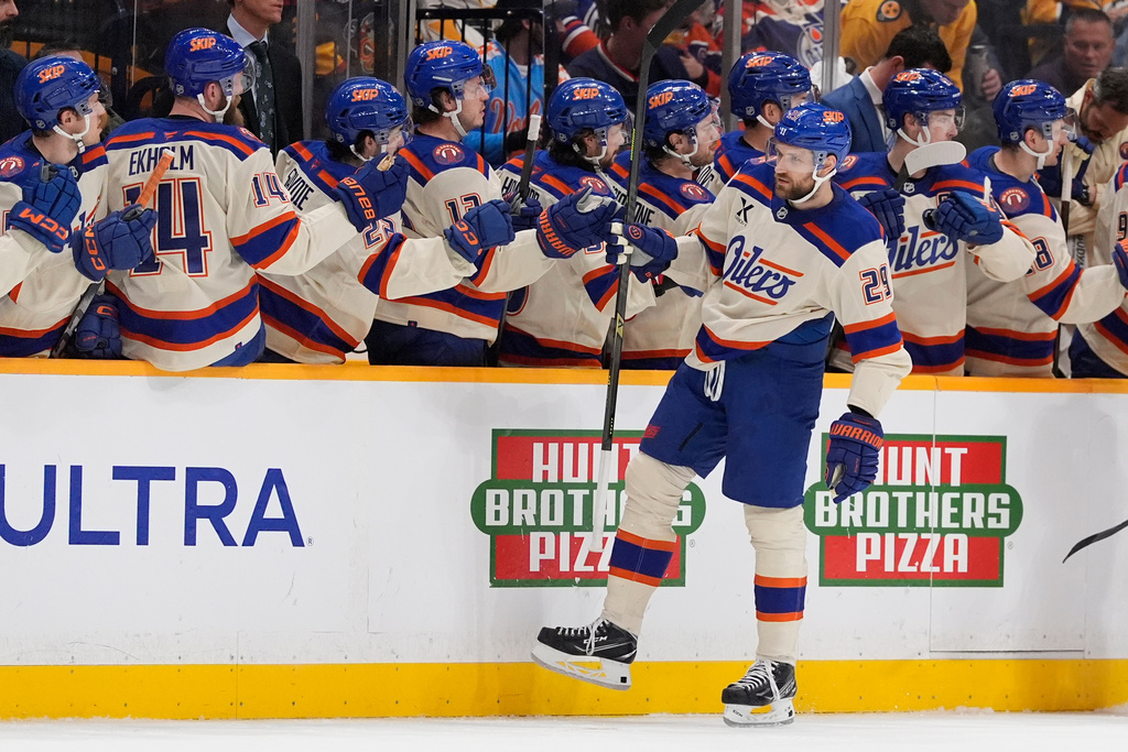 Edmonton Oilers center Leon Draisaitl (29) celebrates his goal with teammates during the second period of an NHL hockey game against the Nashville Predators, Tuesday, Jan. 13, 2026, in Nashville, Tenn. (AP Photo/George Walker IV)