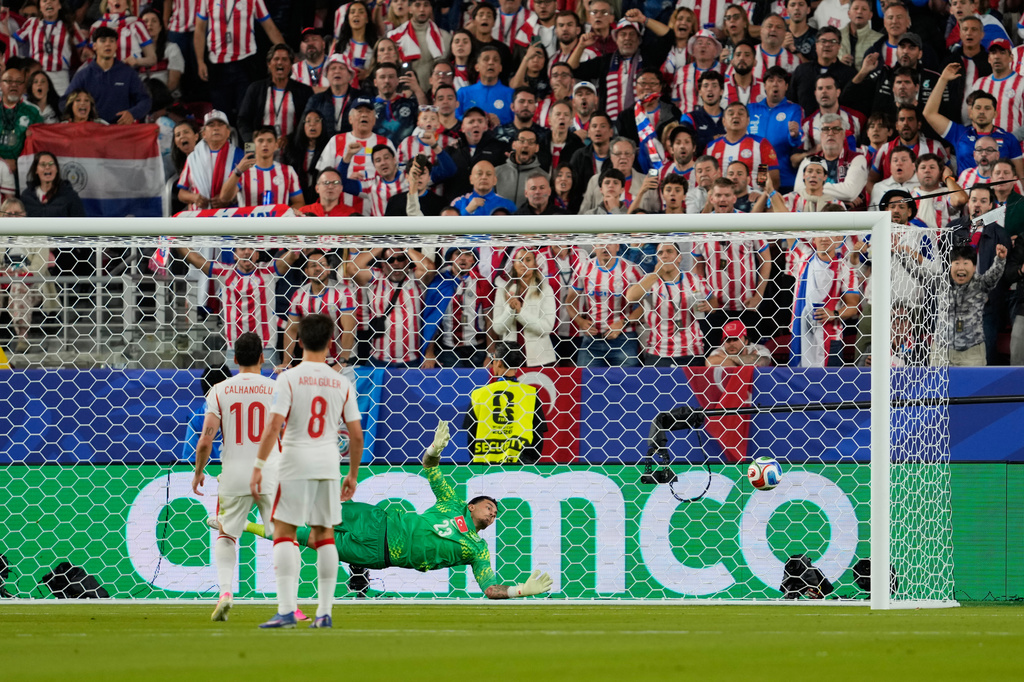 Turkey goalkeeper Ugurcan Cakir (23) makes a save during the World Cup Group D soccer match between Turkey and Paraguay in Santa Clara, Calif., near San Francisco, Friday, June 19, 2026. (AP Photo/Eugene Hoshiko)