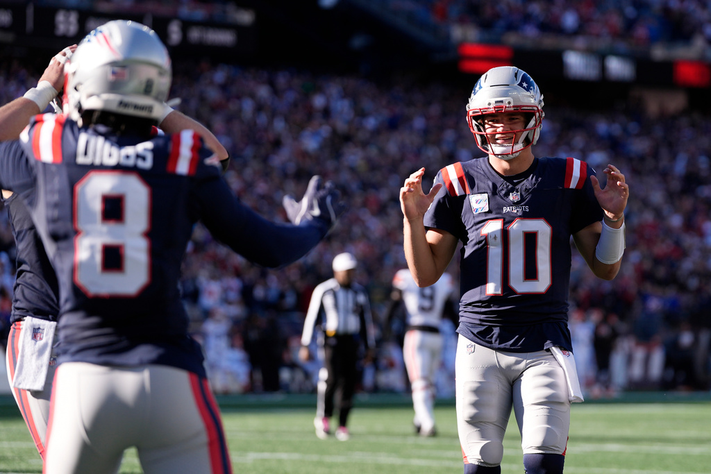 New England Patriots quarterback Drake Maye (10) celebrates after wide receiver Stefon Diggs (8) scored a touchdown against the Cleveland Browns in the second half of an NFL football game on Sunday, Oct. 26, 2025, in Foxborough, Mass. (AP Photo/Charles Krupa)