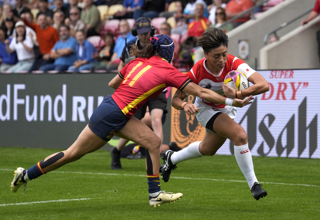 Japan's Sora Nishimura, right, evades Spain's Cara Piquero to score her side's first try of the game, during the Women's Rugby World Cup 2025 Pool C match, at York Community Stadium, in York, England, Sunday, Sept. 7, 2025. (Danny Lawson/PA via AP)