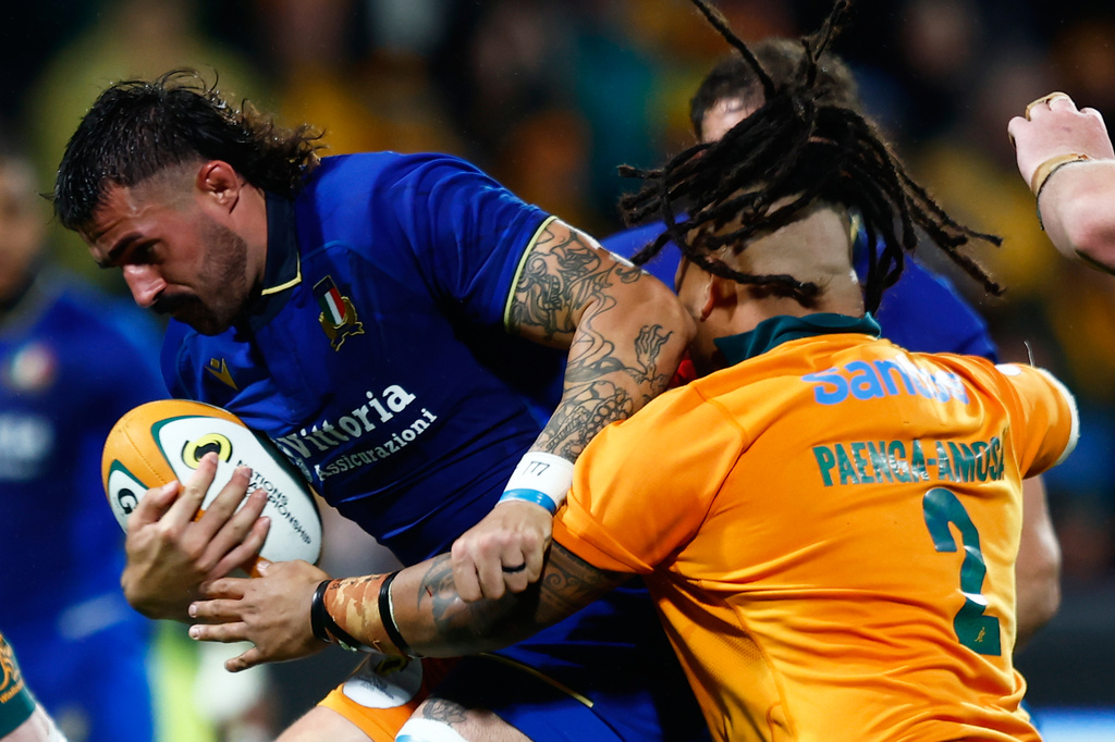 Italy's Riccardo Favretto, left, is tackled by Australia's Brandon Paenga-Amosa during their Nations Championship rugby international test match in Perth, Australia, Saturday, July 18, 2026. (AP Photo/Gary Day)